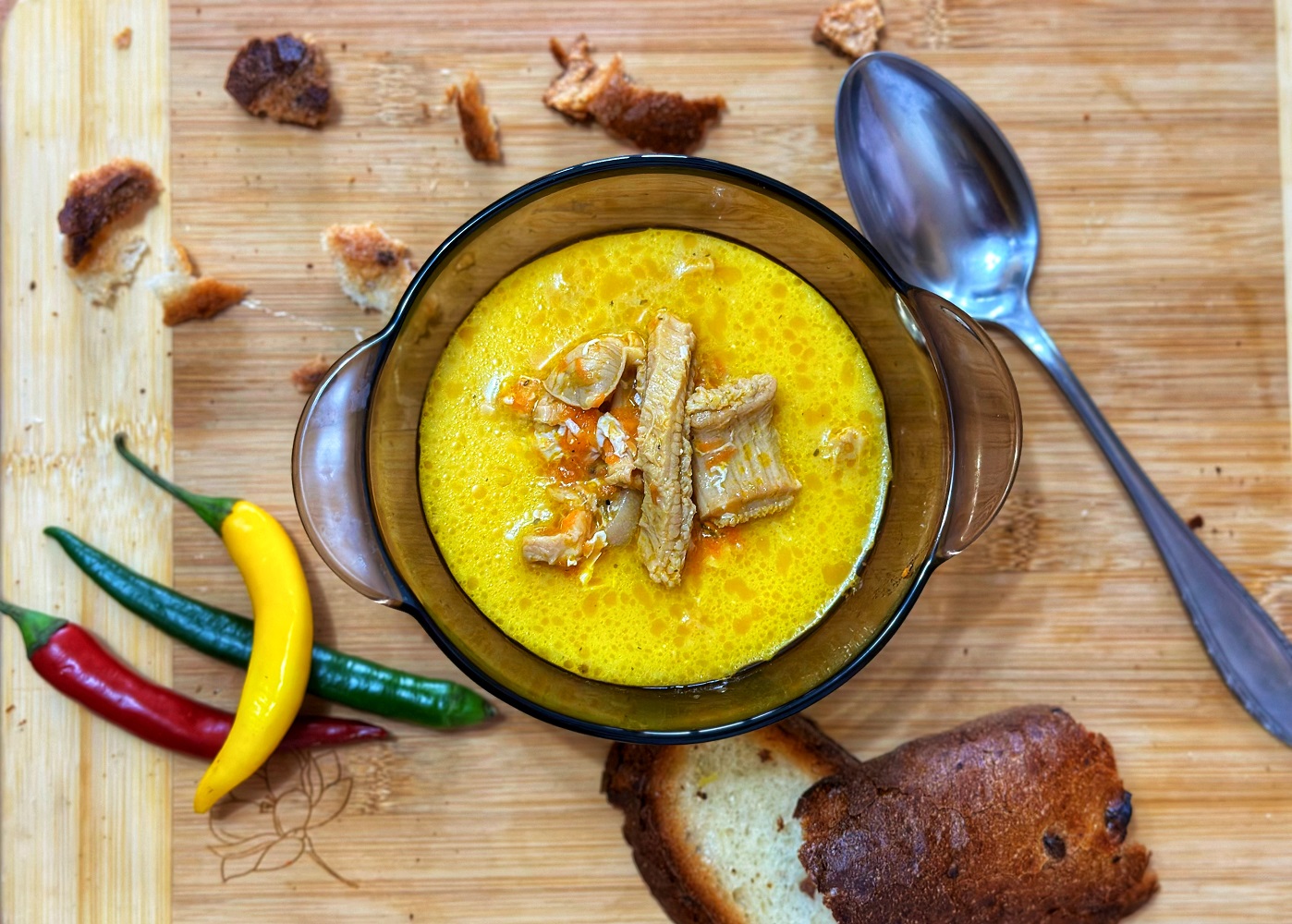 tripe sour soup serving in a bowl with peppers and bread