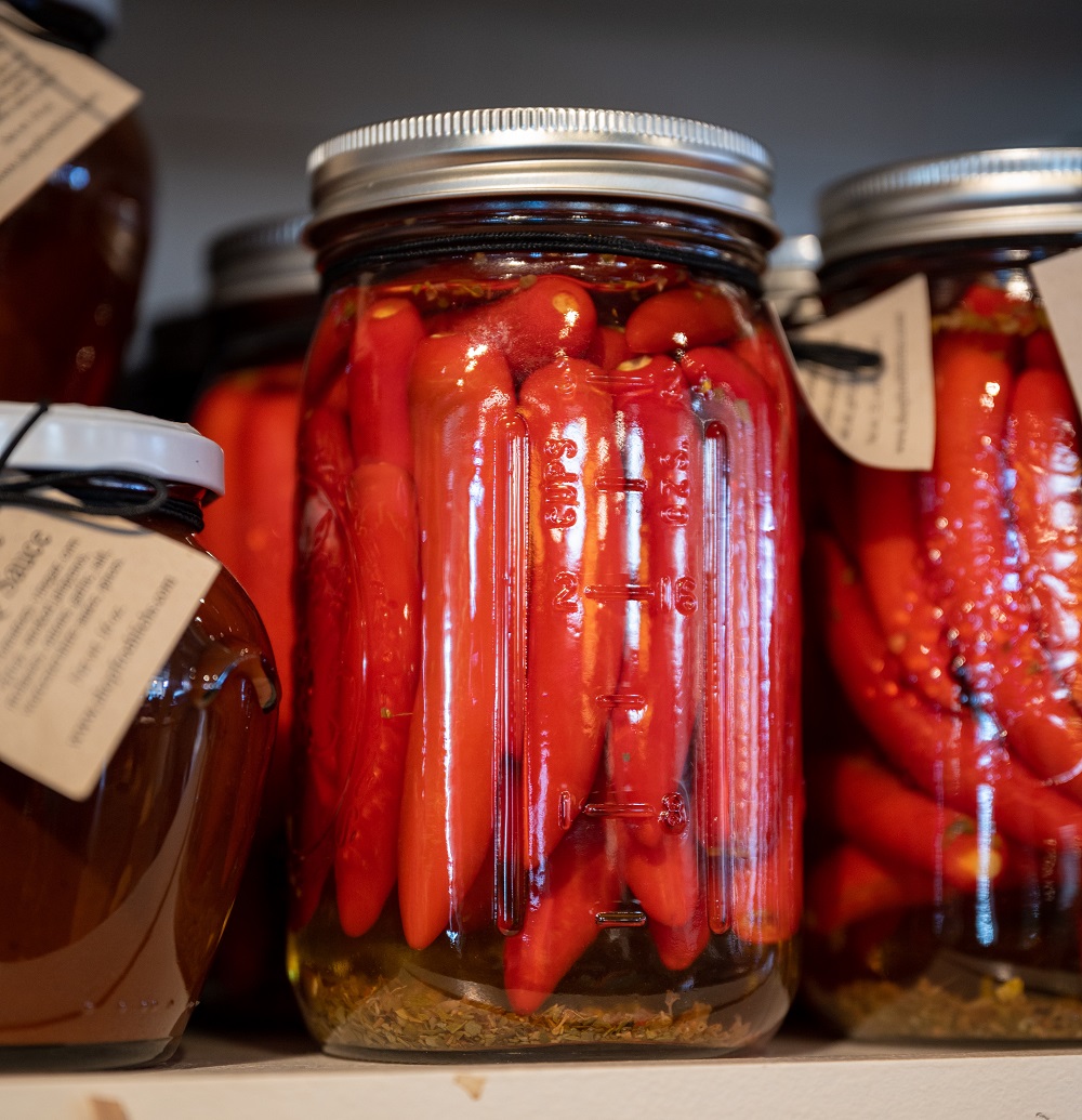 Fresh pickled roasted peppers in jars